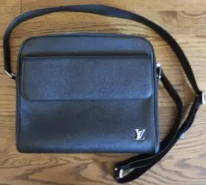 A Louis Vuitton bag in black and grey color