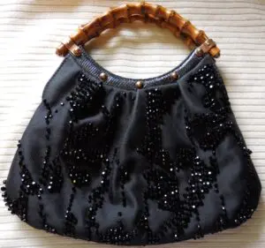 A black color bag with brown color straps