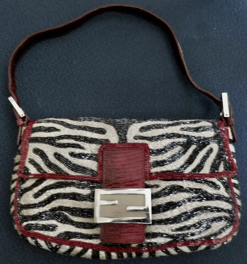 Zebra patterned handbag with Fendi logo.