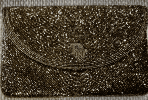 Sparkling beaded clutch with intricate pattern.